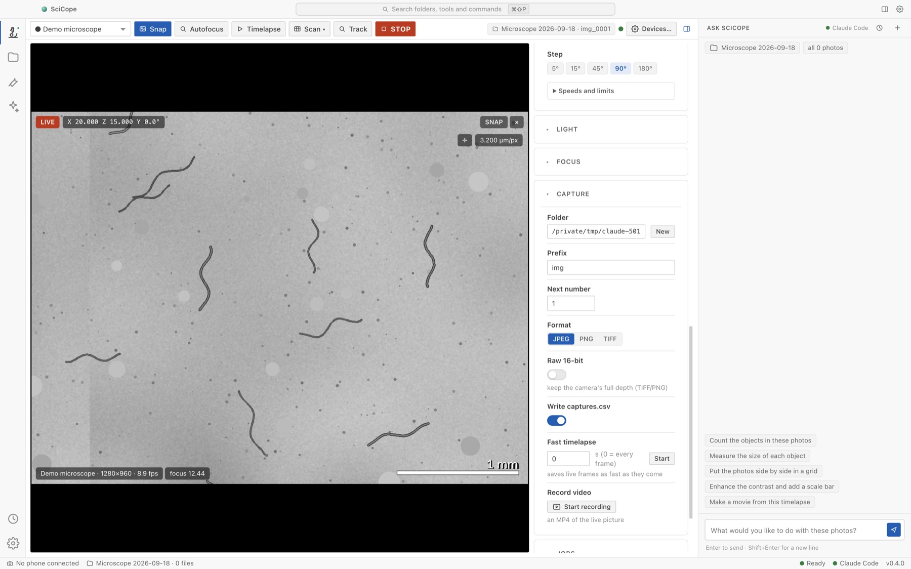 The Microscope view in light mode: the live picture with position, focus score and scale bar, one toolbar with Snap, Autofocus, Timelapse, Scan, Track and STOP, and the camera settings.